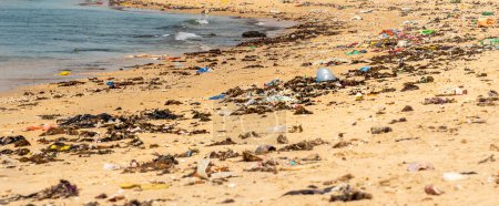 Photo for WARANG, MBOUR, SENEGAL - Circa JANUARY 20222. Beach sand of atlantic ocean with so many garbage plastic pollution in Senegal Africa. No place for tourism on beach to enjoy holidays - Royalty Free Image