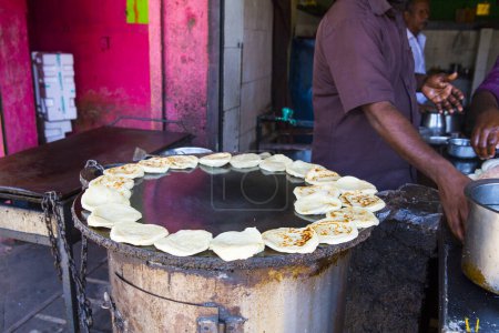 Photo for PONDICHERRY, INDIA - DECEMBER 2019, Circa. Unidentified man in restaurant doing parotta bread for lunch and dinner. Different step to cook it. - Royalty Free Image