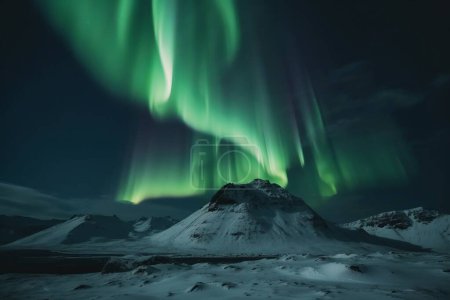 aurora borealis shining in the sky over a snowy landscape in iceland. High quality photo