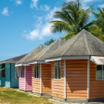 Colorful huts by yhe beach in the Pigeon Point beach klub park in brite sunny day. Tobago Island. Carribean.,