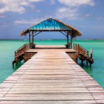 Tobago island, Trinidad and Tobago. An iconic thatch roof jetty at the Pigeon Point Heritage Park located in the south west of the island coast
