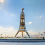 Ashgabat Turkmenistan - October 10 2019: Monument of Neutrality, the three-legged arch built with white marble, gold details and gold-plated statue of Niyazov.