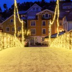 A timeless holiday scene in Norways charming Town with festive illumination on the bridge. High quality photo