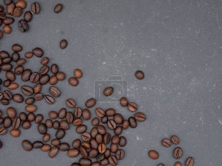 Photo for Top view of scattered coffee beans on black table with copy space for background - Royalty Free Image