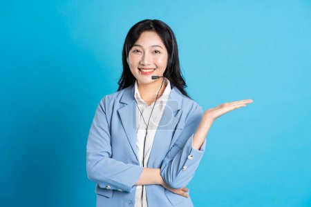 Photo for Portrait of asian business woman posing on blue background - Royalty Free Image