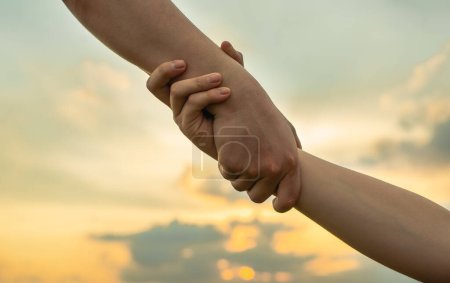Photo for Helping hand outstretched for salvation . Strong hold.; - Royalty Free Image