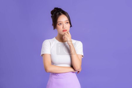 Photo for Portrait of a beautiful Asian woman posing on a purple background - Royalty Free Image