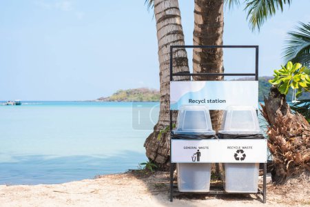 A recycling and general waste station promotes sustainability against a beautiful tropical beach backdrop