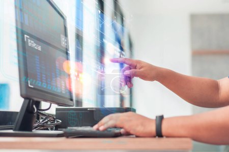 Une personne professionnelle interagit avec un écran d'ordinateur futuriste et high-tech, affichant des analyses de données complexes.