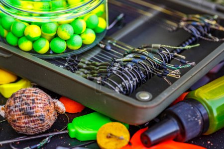 Carpfishing session at the Lake.fishing tools, scissors, carp bait,mixed in dips and stickbaits.Carp fishing rig.The Boilies with fishing hook.