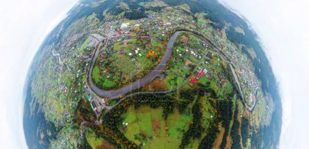 Bird's eye view of the Carpathians in autumn, the mountain village of Verkhovyna, Ukraine, a drone flies over. beech and coniferous forests, houses, roads and a river in the valley 360 circular panorama