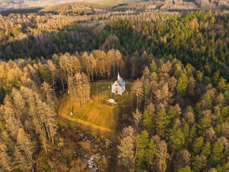 Photo for A small chapel on a hill in the middle of the forest. Chapel of Saint Michael the Archangel in Blizne - Poland - Royalty Free Image
