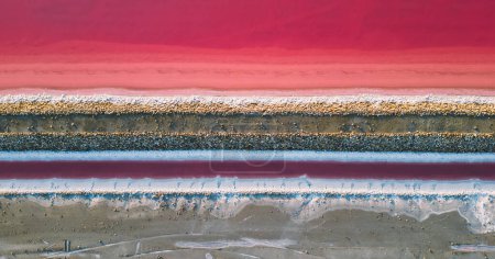Photo for Aerial view of pink salt lake. Salt production plants evaporated brine pond in a salt lake. Salin de Giraud saltworks in the Camargue in Provence, South of France - Royalty Free Image
