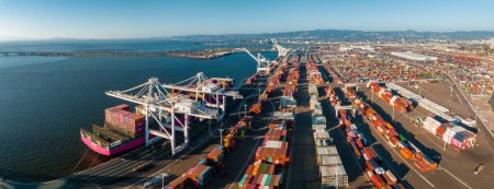 Photo for The Oakland Outer Harbor aerial view. Loaded trucks moving by Container cranes. View of busy Port of Oakland. Shipping terminal facility. - Royalty Free Image