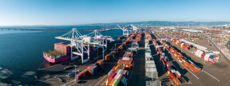 Photo for The Oakland Outer Harbor aerial view. Loaded trucks moving by Container cranes. View of busy Port of Oakland. Shipping terminal facility. - Royalty Free Image