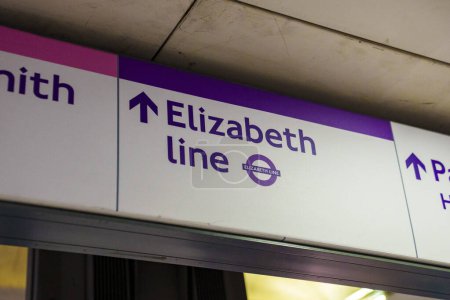 Photo for Low angle view of Elizabeth Line text with arrow symbol on board at underground subway station in London - Royalty Free Image