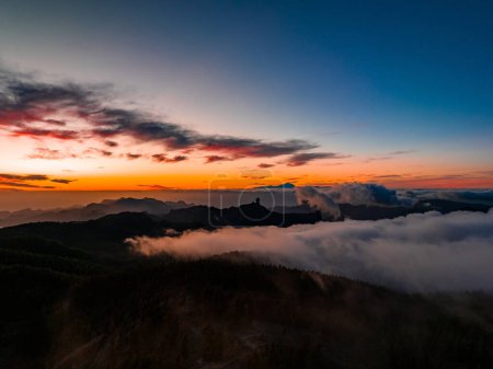 Photo for Magical sunset above the clouds with Teide volcano on the horizon. Sunset cinematic view from the top of Gran Canaria Island Pico de las Nieves point. - Royalty Free Image