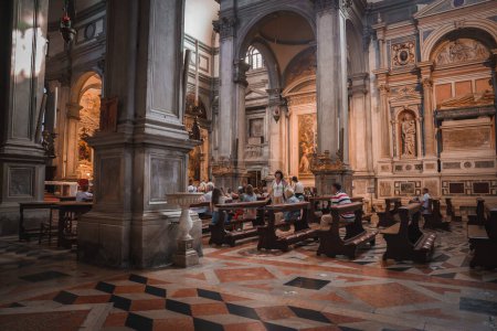 Photo for Interior of a serene and peaceful church with numerous arches and seating. The atmosphere is quiet and calm, with no artwork on the walls in Venice. - Royalty Free Image