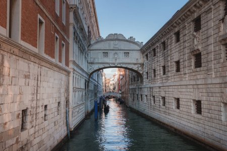 Photo for A peaceful and serene view of a narrow canal in Venice, Italy, with no specific landmarks visible. The canal is typically navigated by gondolas, creating a tranquil atmosphere. - Royalty Free Image
