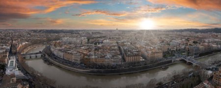 Panoramic view of Rome at sunset with the Tiber River winding through, reflecting the sunsets warm colors. The sky shifts from orange to deep blue, casting a golden glow on the citys architecture.