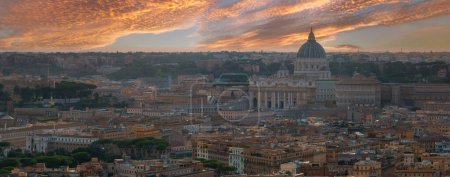 An aerial view of Rome at dusk highlights St. Peters Basilica and warm hued buildings. The sky, with orange, pink, and purple, underscores Romes architectural richness and urban density.