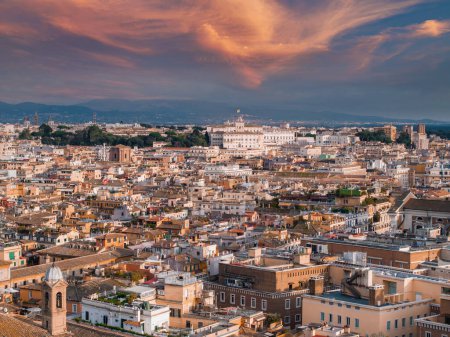 An aerial view of Rome at dusk reveals a sky changing from pink to blue, with the city in golden light. Key buildings and streets showcase its rich history and architectural variety.