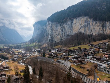 Beautiful autumn time at village of Lauterbrunnen in Swiss alps, gateway to famous Jungfrau. Set in a valley featuring rocky cliffs and the roaring, 300m high Staubbach Falls