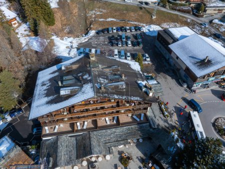 Photo for Aerial panoramic view of the Verbier ski resort town in Switzerland. Classic wooden chalet houses standing in front of the mountains. - Royalty Free Image