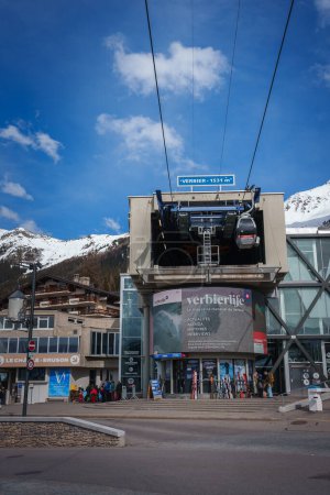 Photo for Modern cable car station in Verbier, Switzerland. Gondola, snowy mountains, and skiers. Elevation of 1531 meters. Pedestrian friendly area with alpine activities. - Royalty Free Image