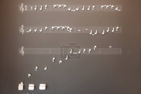 Notes musicales et repose-pieds disposés sur des portées, ressemblant à un décor de partitions sur un fond clair. Représentation de la notation musicale artistique, pas d'Apple Store.