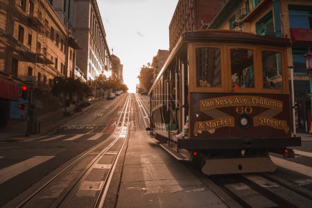 Photo for Iconic San Francisco cable car at Van Ness Ave. California St. and Market St. during golden hour. Classic architecture and hilly streets add charm. - Royalty Free Image