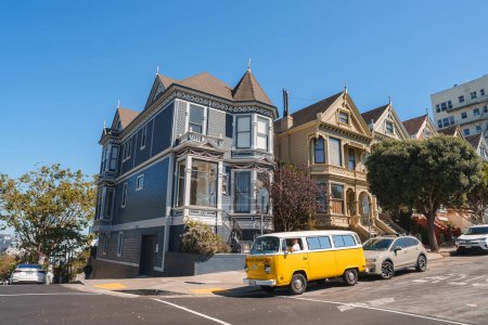 Photo for Sunny day in San Francisco with iconic Victorian architecture and a vintage Volkswagen bus driving on street lined with classic SF homes, showcasing vibrant city culture and history. - Royalty Free Image