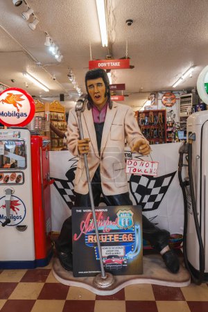 Photo for Explore a nostalgic scene at a Route 66 store with an Elvis Presley figure. Discover vintage decor, a classic gas pump, and themed memorabilia in Williams Town, near the Grand Canyon. - Royalty Free Image