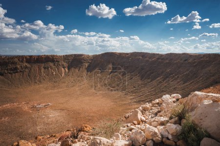 Photo for Panoramic view of Meteor Crater, Barringer Crater, Arizona, USA. Geological wonder formed by meteorite impact 50,000 years ago. Stunning landscape under partly cloudy skies. - Royalty Free Image