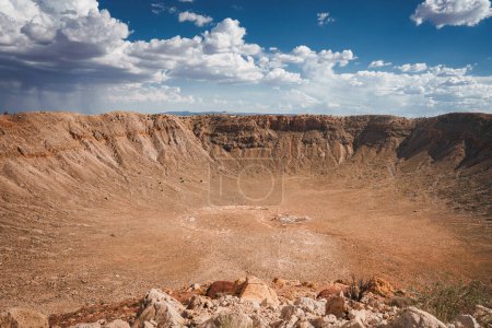 Impressive Meteor Crater, Barringer Crater, Arizona, USA. A geological landmark formed by a meteorite impact 50,000 years ago. Arid desert terrain, steep walls, sparse vegetation.
