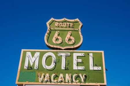 Foto de Vintage motel sign featuring iconic Route 66 design against blue sky in Barstow, USA. Classic mid 20th century roadside advertising with nostalgic charm. - Imagen libre de derechos