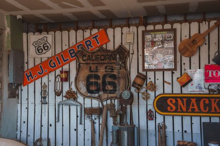 Photo for Vintage Americana collection featuring iconic Route 66 memorabilia, including road signs, antique tools, and nostalgic items at a location in Barstow, USA. - Royalty Free Image