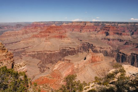 Photo for Expansive view of Grand Canyon, Arizona, USA, showcases stunning red rock layers, clear sky, deep gorges, rugged terrain. No people visible, untouched beauty captured. - Royalty Free Image