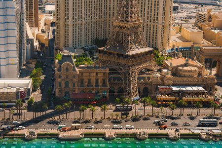Photo for Aerial view showcasing Las Vegas Strip with Eiffel Tower replica and urban landscape. Palm trees, water, themed architecture, bustling atmosphere. Ideal for travel blogs. - Royalty Free Image