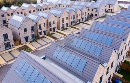 Aerial view of rows of new build, energy efficient modular terraced houses in the UK with characterless design for first time buyers