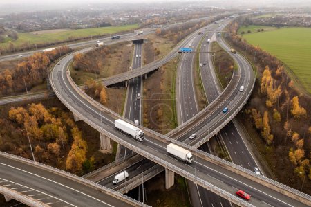 Photo for FERRYBRIDGE, YORKSHIRE, UK - DECEMBER 1, 2022.  An aerial view above a complex motorway junction with slip roads and overbridges connecting the M62 and A1 motorways in the UK - Royalty Free Image
