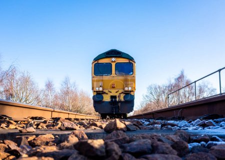 Téléchargez les photos : A point of view image of the front of a freight locomotive moving towards a person on the railway line in a suicide or occupational safety concept - en image libre de droit