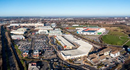 Photo for DONCASTER, UK - JANUARY 19, 2023. Aerial view of the Lakeside Village shopping centre and Doncaster Rovers Football Club Eco Power stadium in a Doncaster cityscape skyline - Royalty Free Image