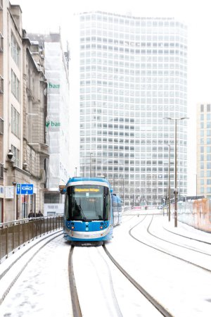 Photo for BIRMINGHAM, UK - MARCH 9, 2023.  West Midlands Tram in Birmingham city centre during travel disruption caused by heavy snow - Royalty Free Image
