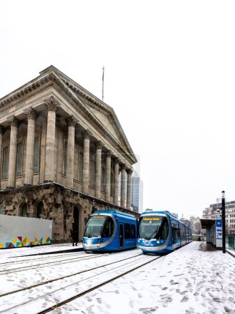 Photo for BIRMINGHAM, UK - MARCH 9, 2023.  West Midlands Trams at Birmingham Town Hall building during Winter with heavy snow on the ground disrupting traffic - Royalty Free Image