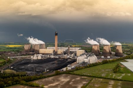 Aerial landscape view of Drax Power Station in North Yorkshire with smoking chimneys and cooling towers pumping CO2 pollution into the atmosphere