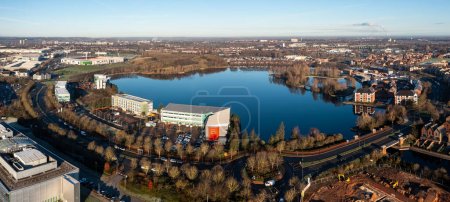 Photo for An aerial view of the lake at Lakeside Village in Doncaster with shopping outlet and Doncaster Rovers FC Eco-Power football stadium - Royalty Free Image