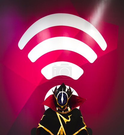 A masked superhero cosplay male in a funny outfit transmitting on a wifi signal