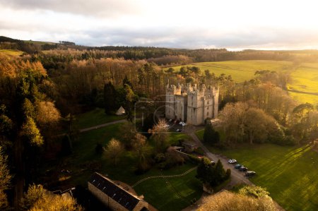 Photo for LANGLEY CASTLE, NORTHUMBERLAND, UK - MARCH 16, 2024. An aerial view of the historic and medieval architecture of Langley Castle near Haydon Bridge in Northumberland at sunrise - Royalty Free Image