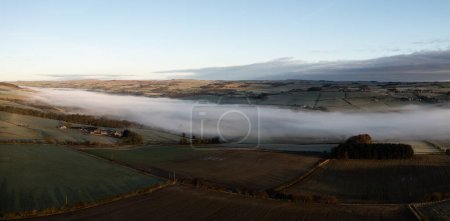 Aerial view of low lying mist or cloud inversion along the River Tyne valley at Haydon Bridge near Hexham on a cold Winter morning
